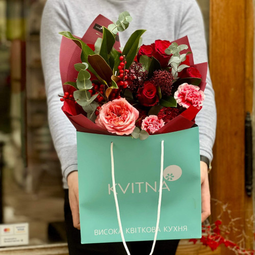Red bouquet with roses, ilex and exotic leucospermum «Ardent look»