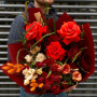 Bright bouquet with red roses, interesting ranunculus and eustoma «Fiery fox»