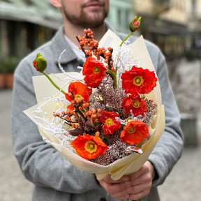 Bright orange bouquet of papaver and ilex with snow elements «Christmas light»