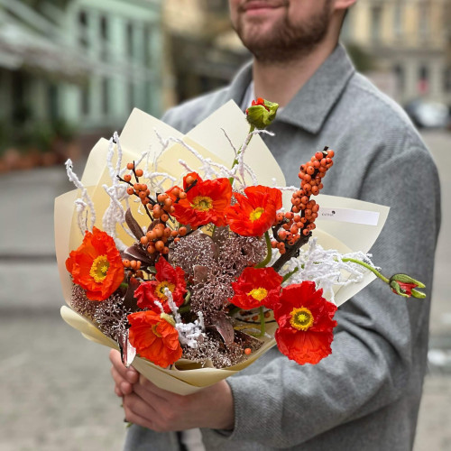 Bright orange bouquet of papaver and ilex with snow elements «Christmas light»