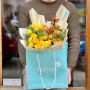 Bright yellow bouquet of spray peony roses and ilex «Sunny berries»