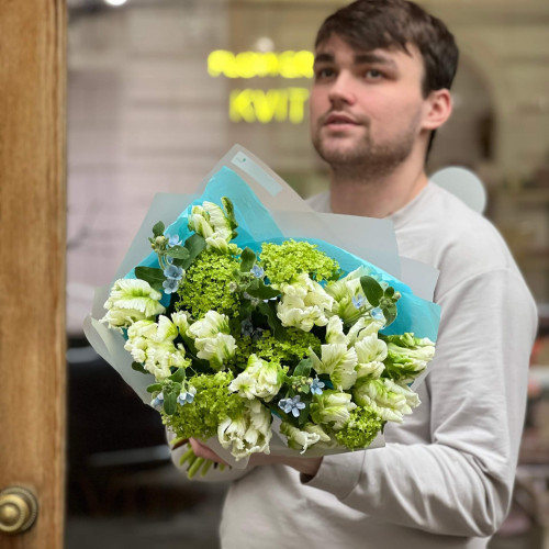 Spring bouquet of variegated tulips, viburnum and oxypetalum «Green wave»