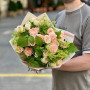 Lush bush rose in a bouquet with alchemilla and raspberry greenery «Orange Mousse»