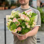 Lush bush rose in a bouquet with alchemilla and raspberry greenery «Orange Mousse»