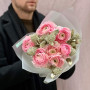 Delicate pink bouquet of 7 ranunculi and skimmia