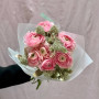 Delicate pink bouquet of 7 ranunculi and skimmia